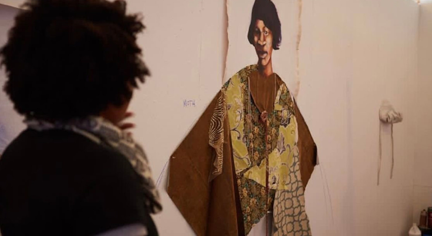 woman looking at a woman painting