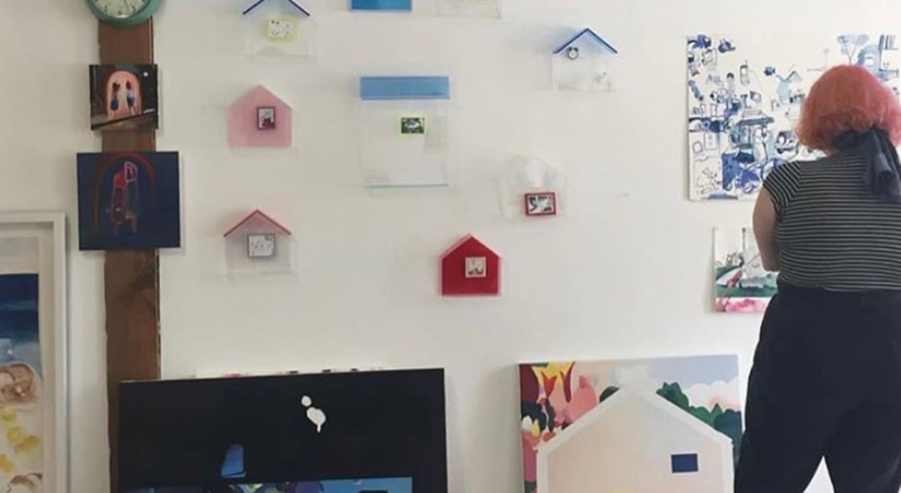 woman looking at paintings